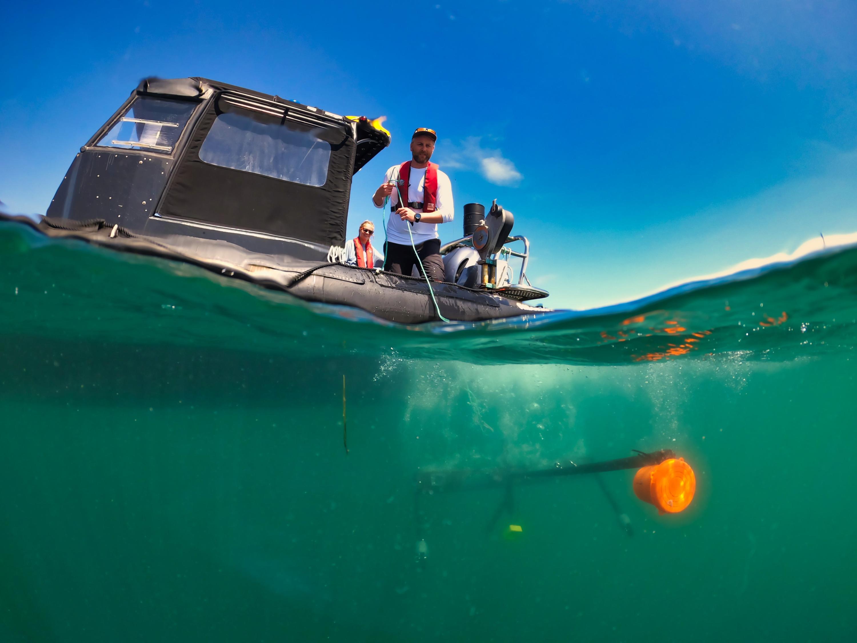 Dr Owen Exeter deploying a Baited Remote Underwater Video from the Isles of Scilly IFCA rib