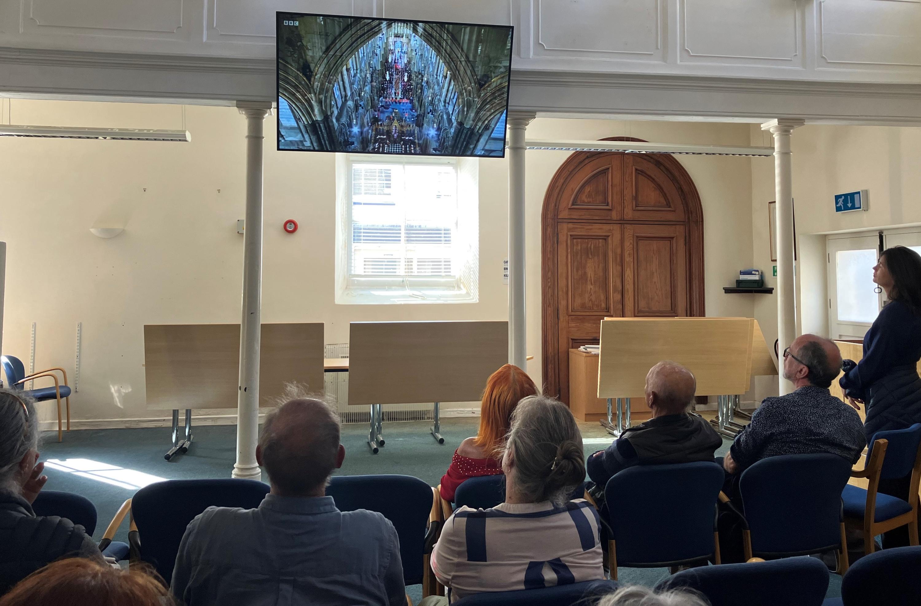 Image of people watching the State Funeral of Queen Elizabeth II at the Wesleyan Chapel on St Mary's