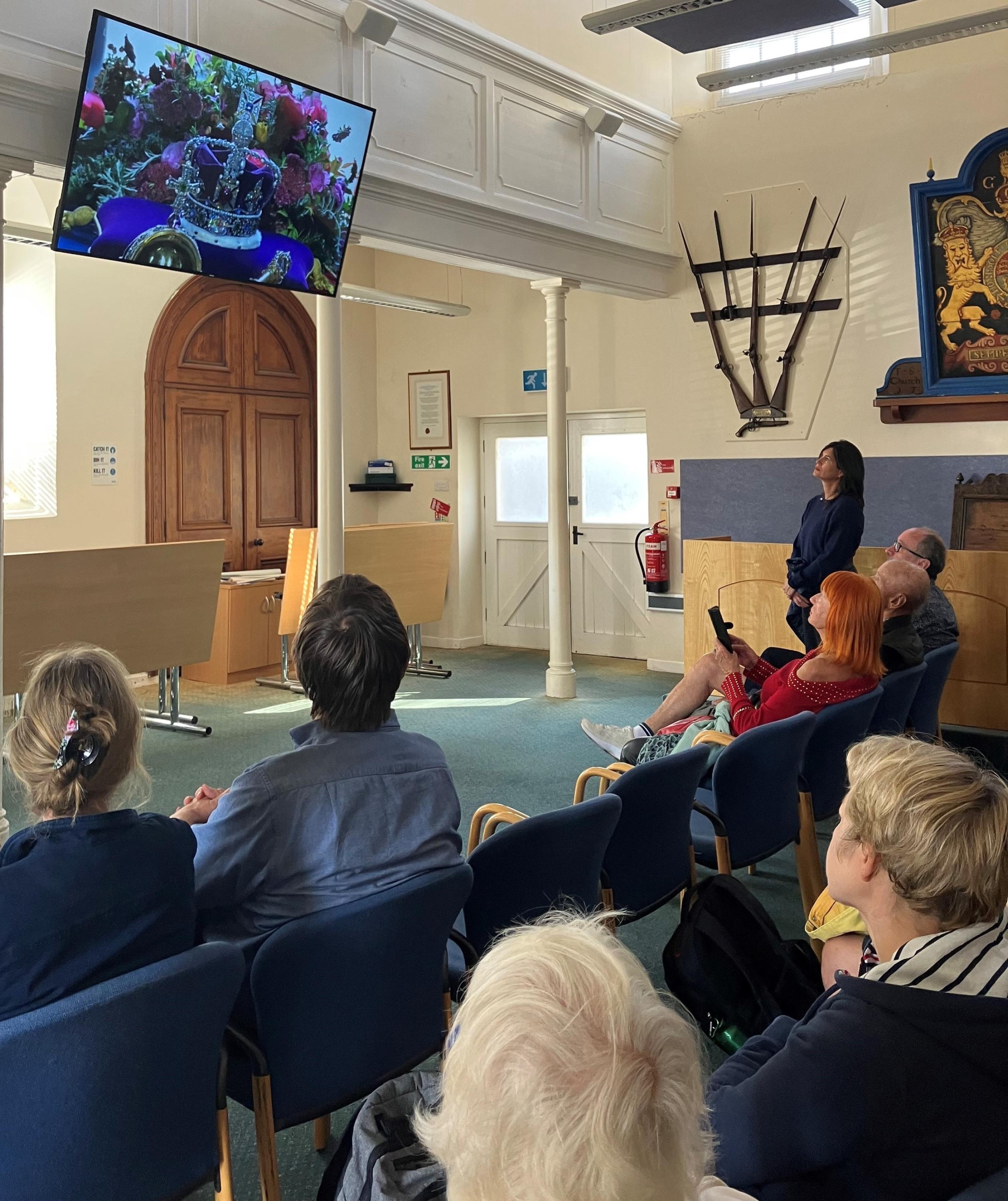 Image of people watching the State Funeral of Queen Elizabeth II at the Wesleyan Chapel on St Mary's