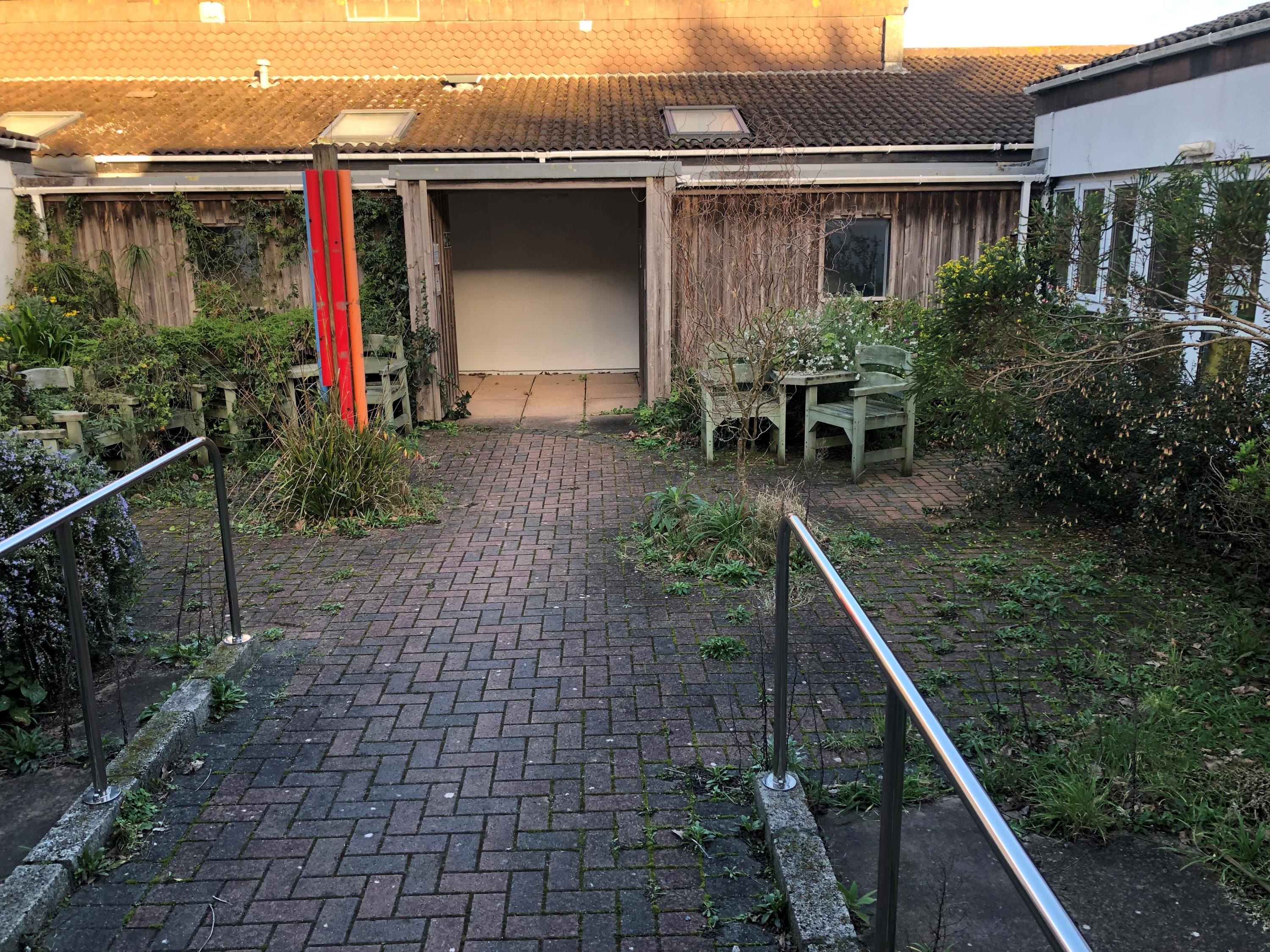 Photograph of the courtyard area at the Carn Gwaval Wellbeing Centre prior to work being undertaken on the garden